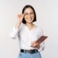 Image of young asian business woman, female entrepreneur in glasses, holding tablet and looking professional in glasses, white background.