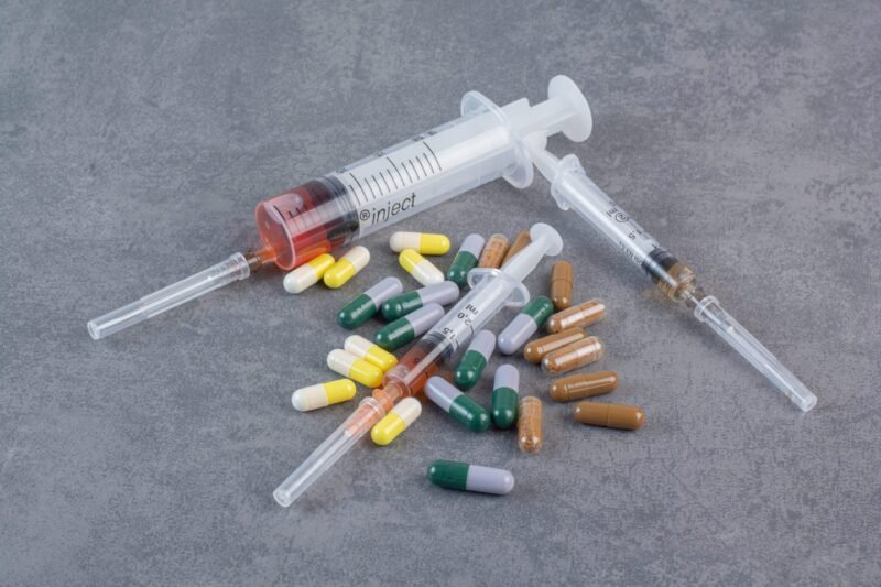 Assorted pharmaceutical capsules and syringes with serums. High quality photo